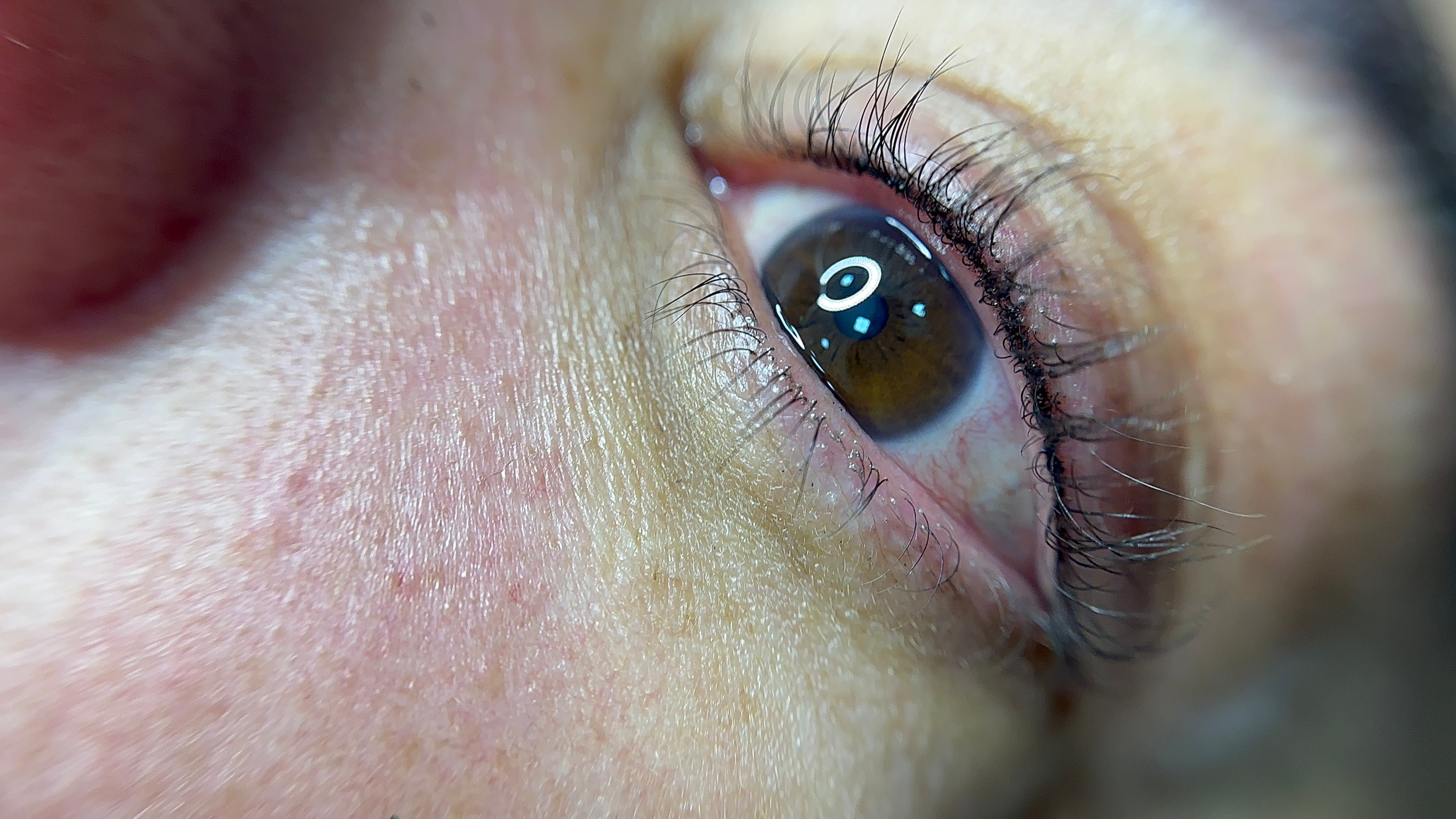 A subtle lash line eyeliner tattoo enhancing the natural eye shape.