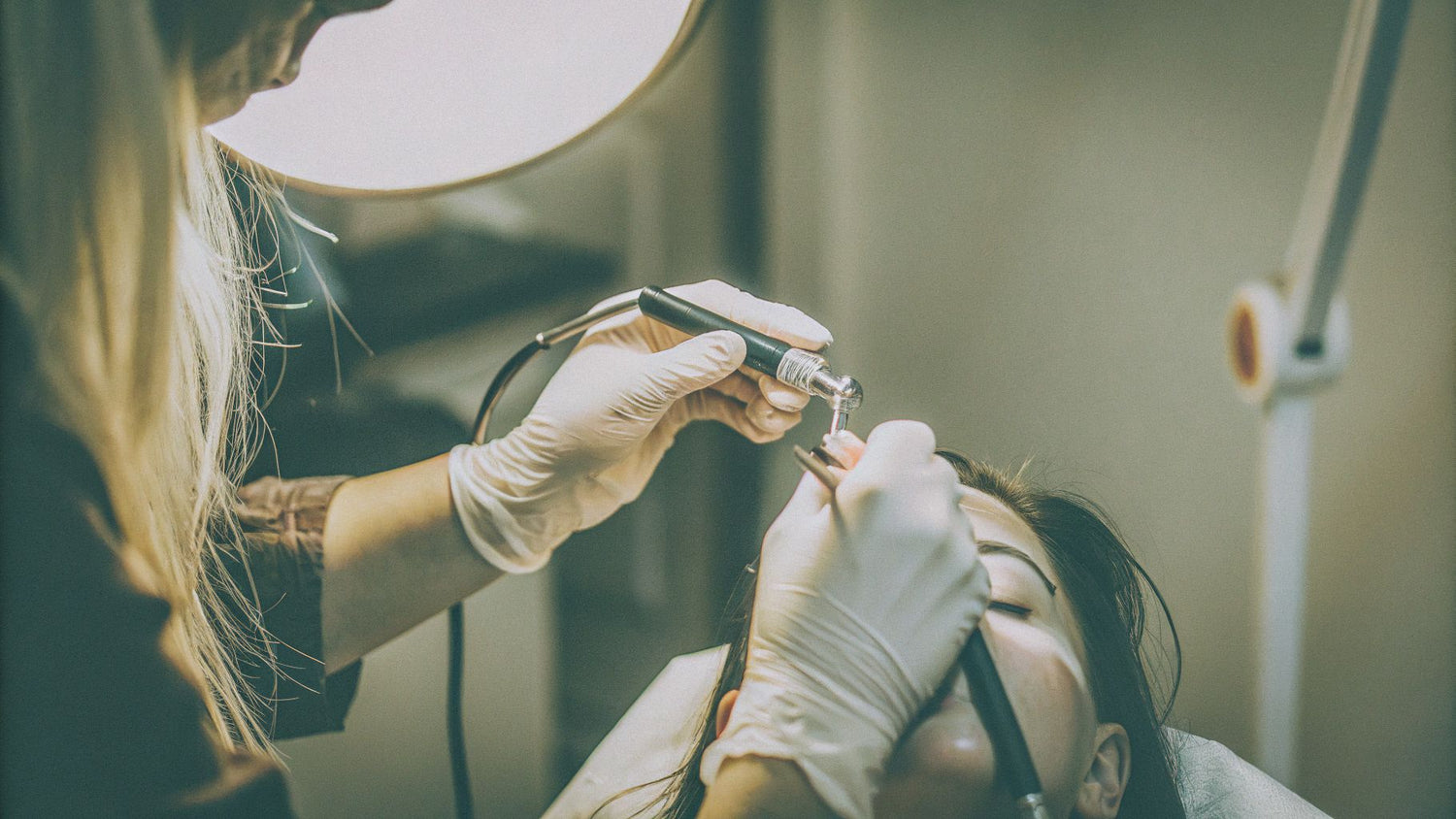 Professional powder brows technique demonstration in luxury salon setting