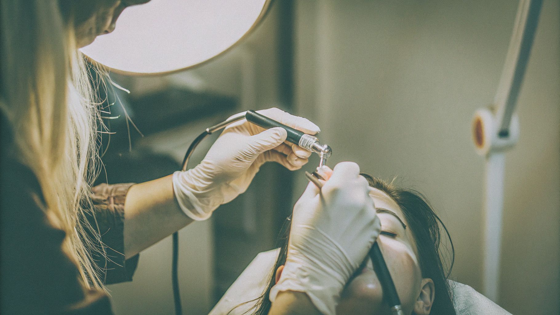 Professional powder brows technique demonstration in luxury salon setting