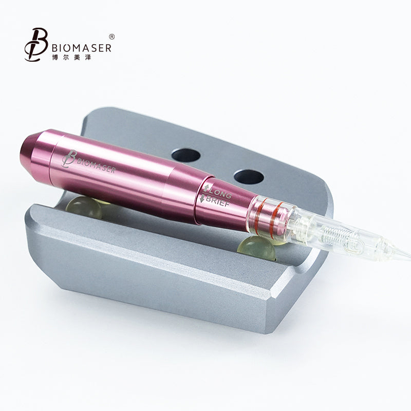 Biomaser pink PMU handpiece with cartridge needle on a silver stand, LONG BRIEF marking, professional tattoo equipment