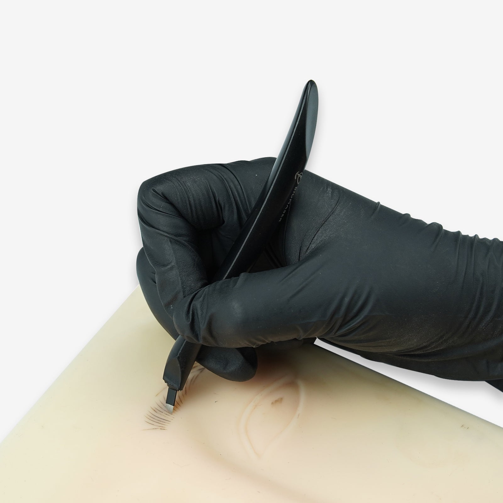 Biomaser disposable microblading pen in use, black plastic handle with blade, for professional eyebrow permanent makeup