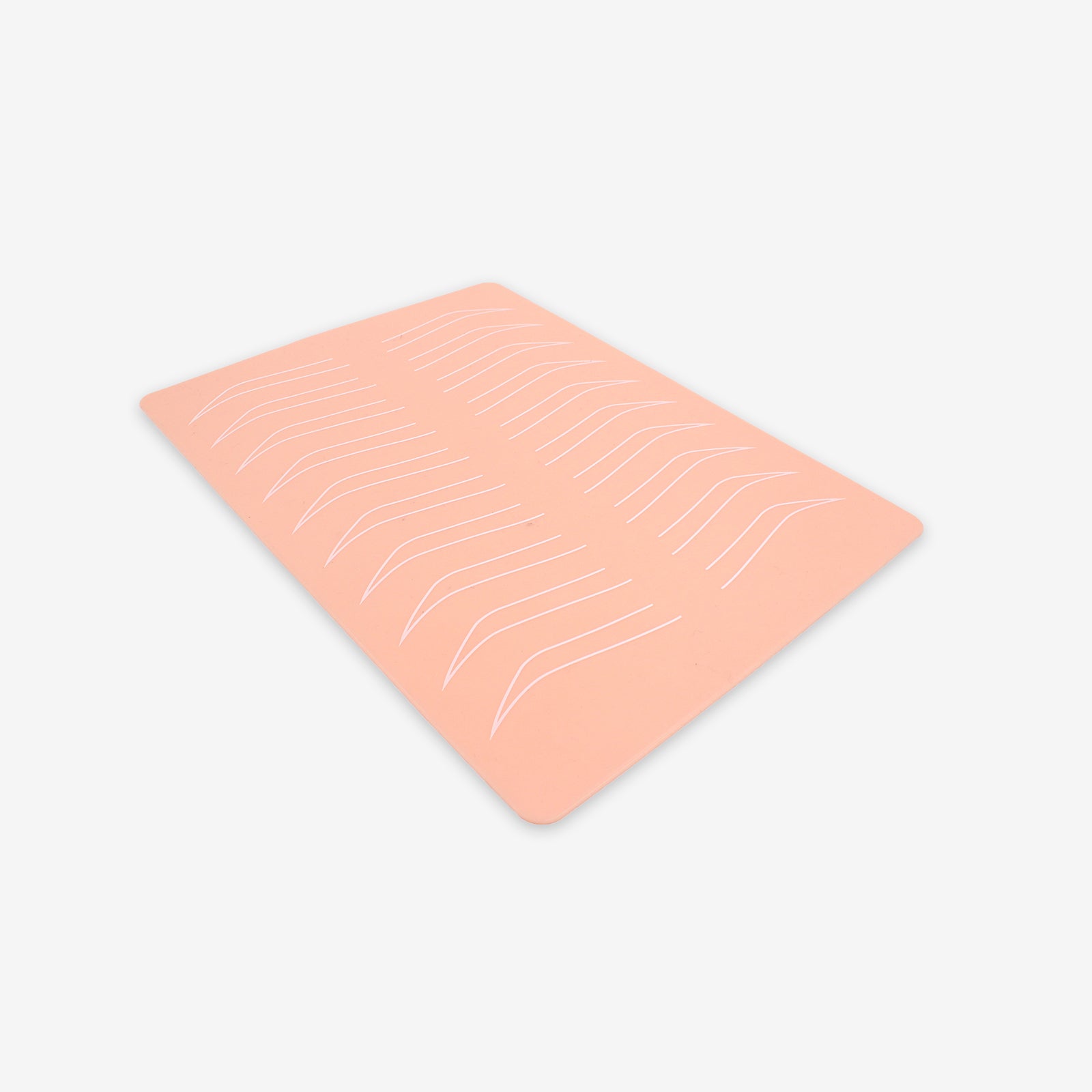 Peach silicone microblading practice skin with eyebrow outlines for tattoo training, tattoo equipment.