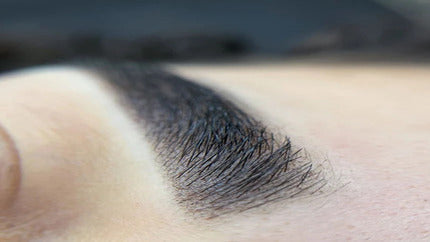 Close-up of professionally done Eyebrow Tattoo with natural-looking texture.