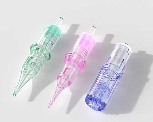 Colorful PMU cartridge needles in green pink and clear showing variety of permanent makeup needle options.