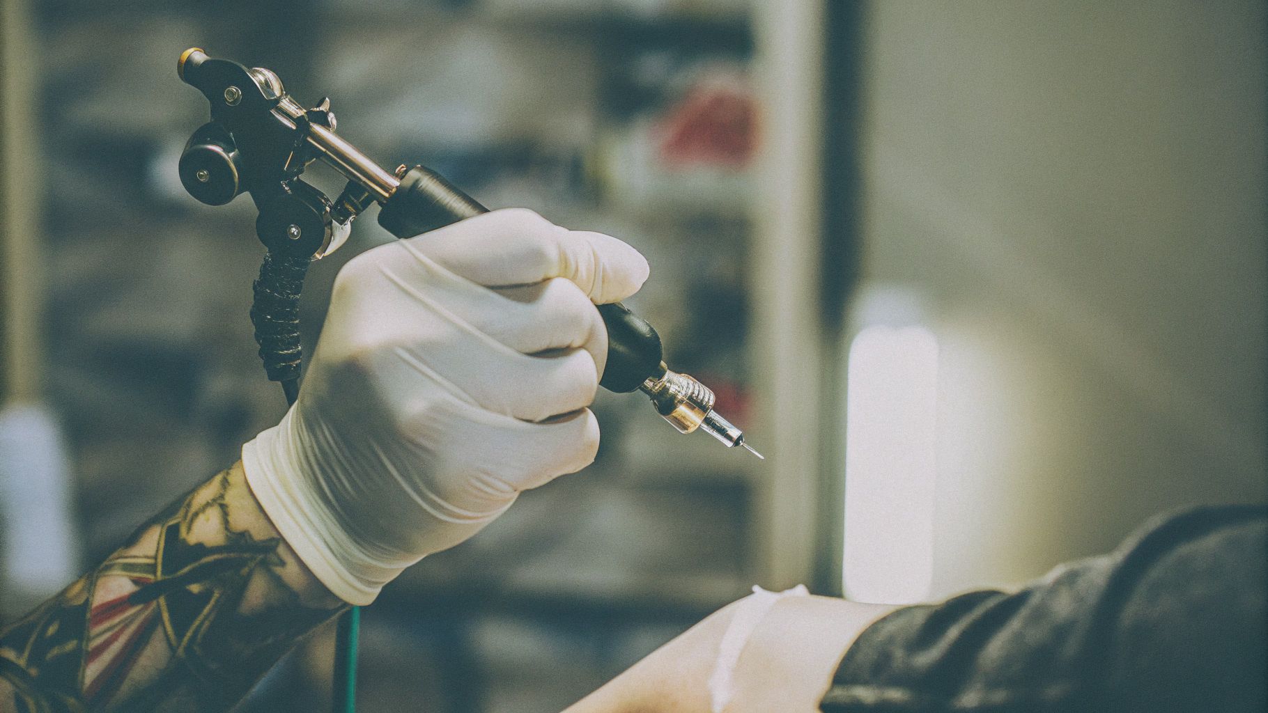 Professional using PMU Machine with gloved hands for permanent makeup.
