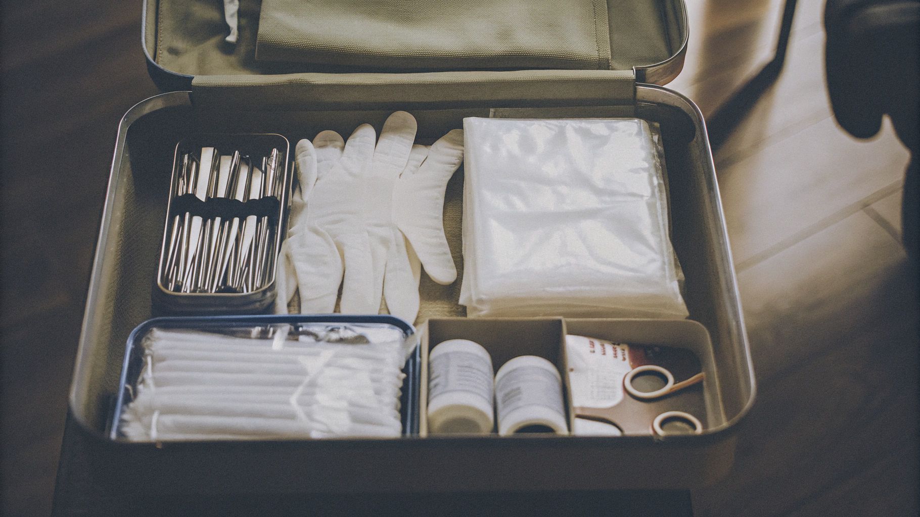 Fully-stocked first aid kit for tattoo studios, including gloves, antiseptics, and bandages.